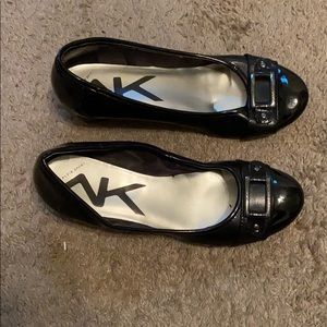 A black pair of women’s flats.